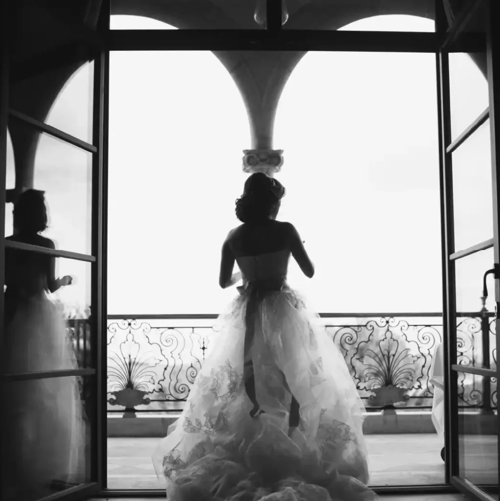 Bride poses in elegant dress overlooking the balcony at Castillo Son Vida