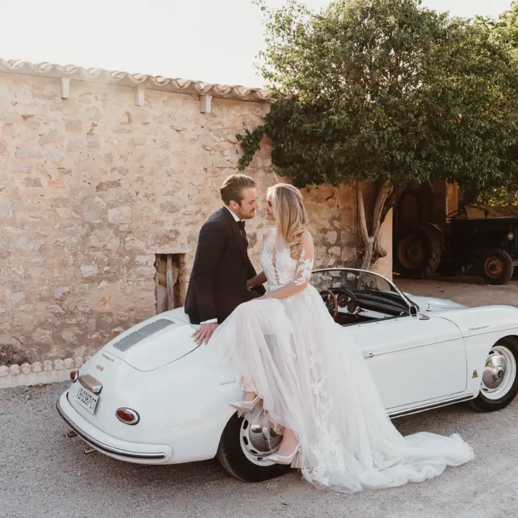 After their wedding in Mallorca at Finca Biniorella, the couple are posing with a vintage Porsche 356