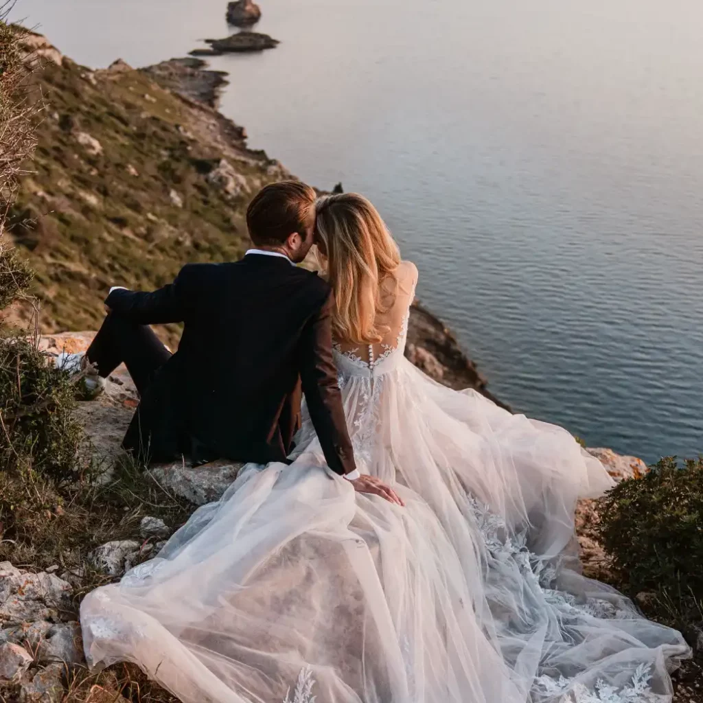 The newly weds are enjoying the sunset over the cliffs. A peaceful moment after their wedding in Mallorca is very welcome.