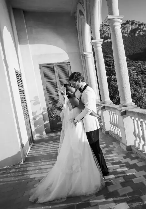 Couple standing on elegant balcony during their elegant wedding in Mallorca at the Venue Son Marroig