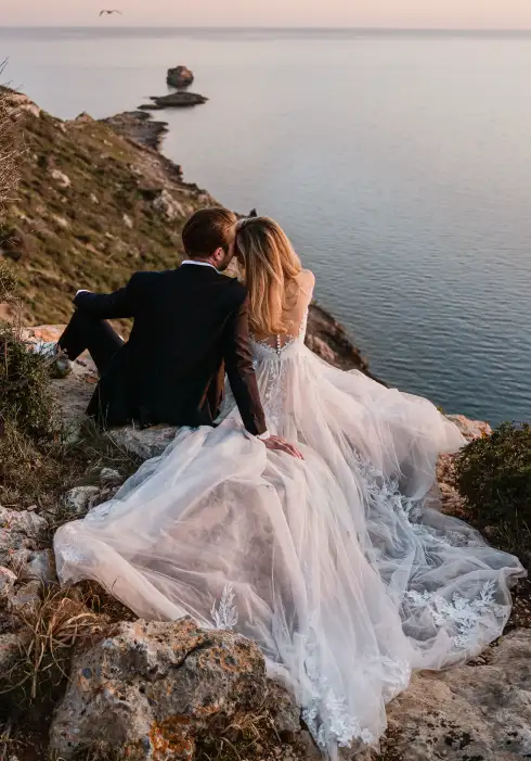 Bride and groom enjoying the sunset over the cliffs during their Mallorca wedding