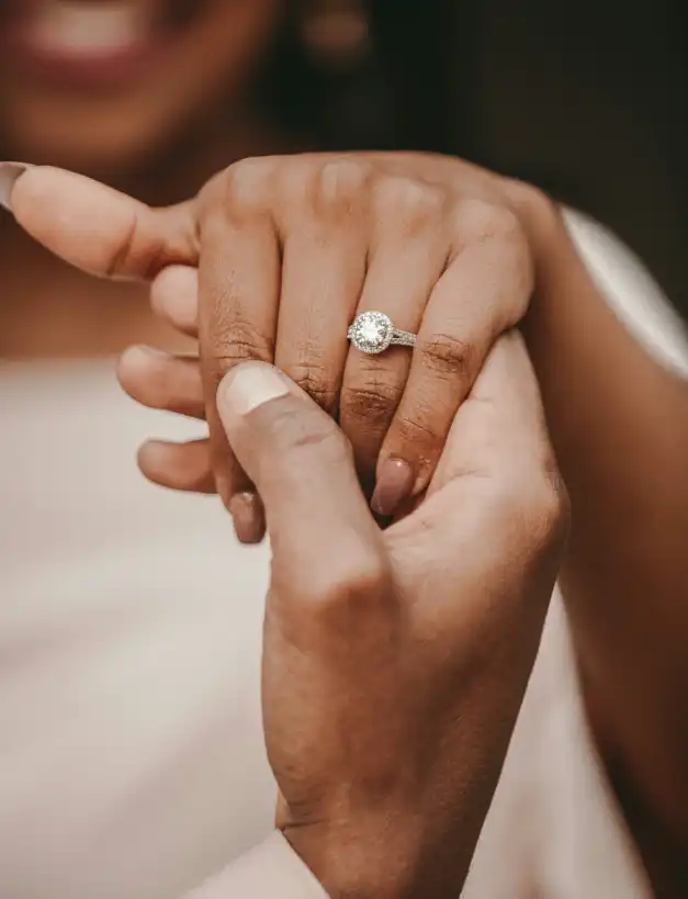 Close-up of a couple's hands during a romantic wedding proposal in Mallorca, showcasing a stunning diamond engagement ring