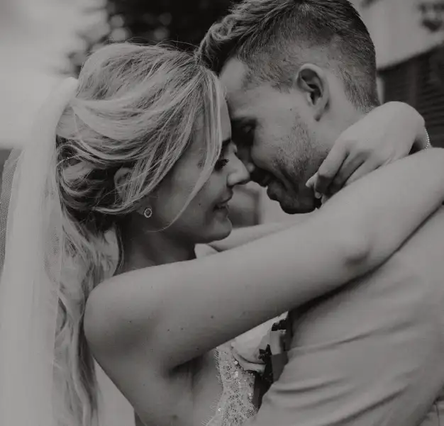 A newlywed couple embracing intimately after their destination wedding in Mallorca, capturing their love and joy on their special day.