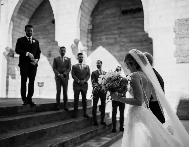 A bride walking towards her groom during an intimate elopement ceremony in Iglesia Nova